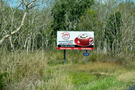 Bruce Highway, Townsville to Mackay, Queensland, Australia - November 2021: Coffee shop outdoor signpost amongst rural bushlandのeditorial素材
