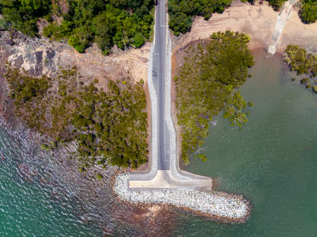 Directly above a boat ramp on the ocean with surrounding vegetation at St Helens Beach Queensland Australiaの写真素材