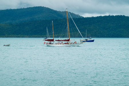 Airlie Beach, Queensland, Australia - January 2022: Tourists enjoying a sail on a luxury yacht
