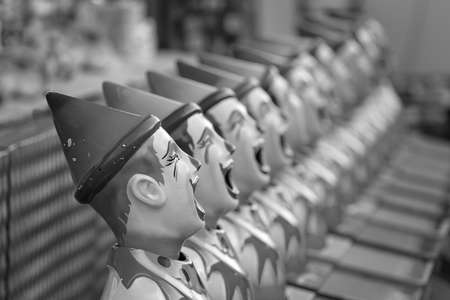 Clowns for the ball in the mouth game on side show alley at a country showの写真素材