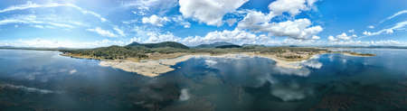 A panorama of Kinchant Dam, Mackay, Queensland, Australia., with clouds reflected in the water on a still day.の写真素材