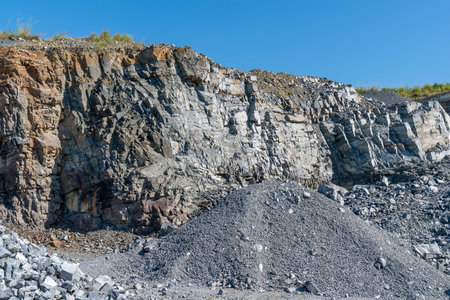 Rock being excavated at a quarry to industrial use in the building of roads etc.