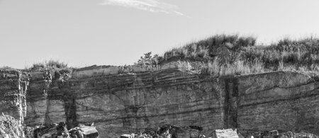 Rock being excavated at a quarry to industrial use in the building of roads etc. Layers in the rock...