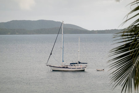 Airlie Beach, Whitsundays, Queensland, Australia - April 2022: A luxury yacht and dingy anchored off...