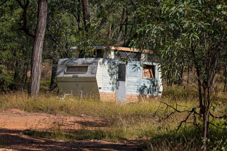 An old abandoned caravan amongst the bush at the Reward diggings near Rubyvale on the gemfields in Queensland, Australia.の写真素材