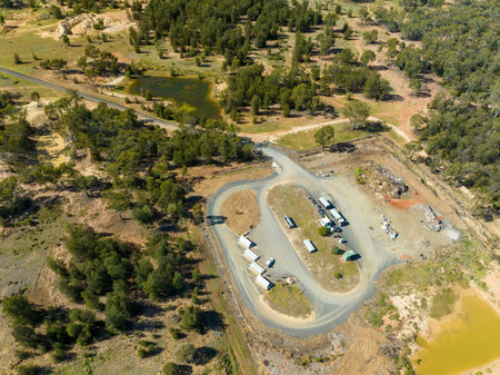 Drone aerial view looking down over sapphire mine diggings and industrial site in central Queensland...