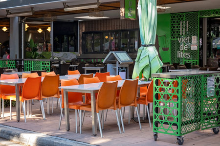 Brisbane, Queensland, Australia - August 2022: Empty tables and chairs of an outdoor restaurant not yet open for service.のeditorial素材