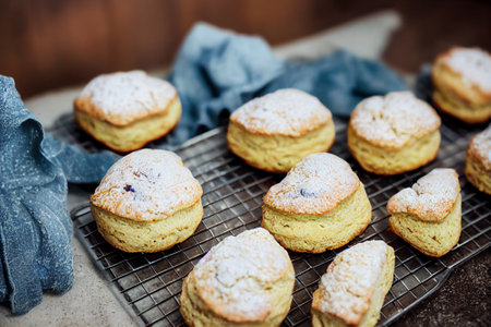 Food illustration - freshly baked scones straight out of the oven and on a wire tray to cool.の写真素材