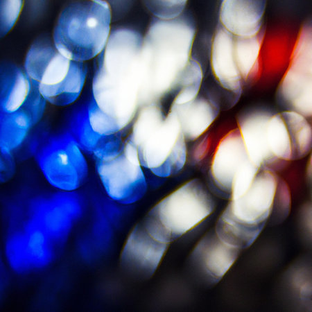 Blurred lights background texture to overlay onto images in your favorite editing program with specific blending modes. Bokkeh colors are blue, white and red.の写真素材