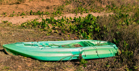 Kayak abandoned on the beachの写真素材