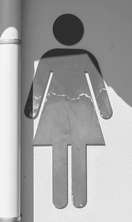 Shape of a woman in a dress indicating female toiletの写真素材