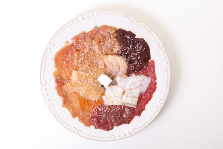 Raw pork steaks, minced meat and slides of ham on the plateの写真素材