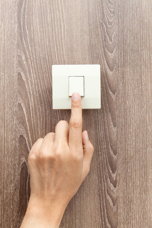 One finger switching turned on off, press the button, wood wall background