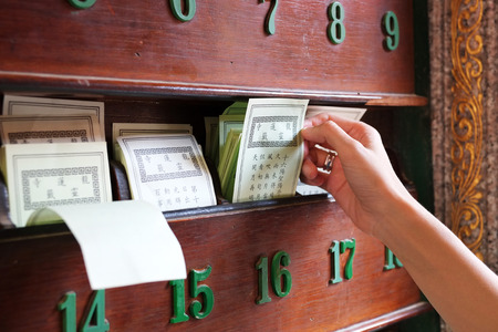 Hand keep fortune paper on shelf, Tradition of Chineseの写真素材