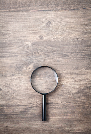 Magnifying glass on wood tableの写真素材