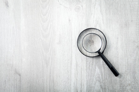 Two magnifying glass on wood backgroundの写真素材
