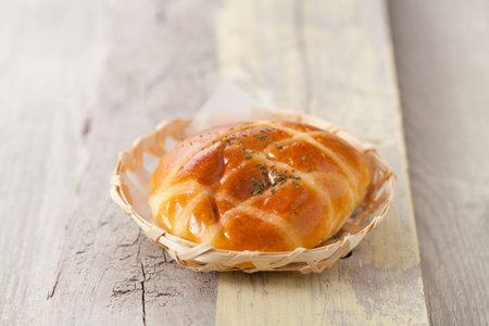 Homemade bread in basket on wooden table, Selective focus