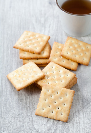Stack of square crackers on wooden tableの写真素材