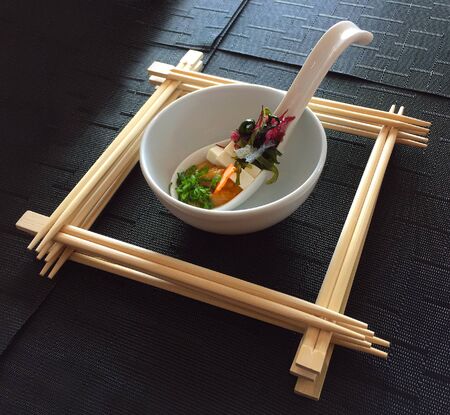 A beautifully prepared bowl of sushi surrounded by chopsticksの写真素材