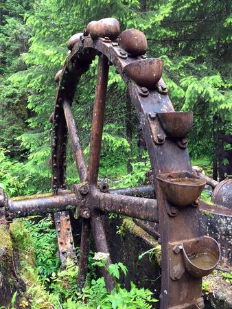 A large rusty water wheel for excavating mineralsの写真素材