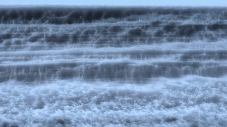 Layers of ice and snow packed tightly forming different textures