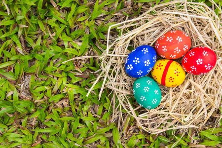 Painted Easter eggs put on the straw in the grass.easter day