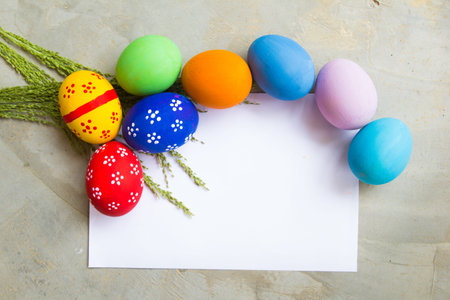 Painted Easter eggs put on the Polished floor and a paper note,easter day