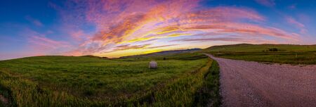 Gorgeous Sunset Over a Hay Bale In a Fieldの写真素材