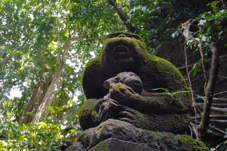 Monkey statue in covered with moss, Indonesia
