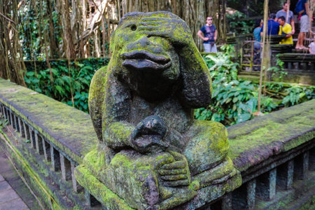 Monkey statue in covered with moss, Indonesia