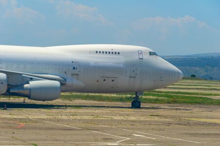 nose of the white unbranded abondened commercial airplaneの写真素材