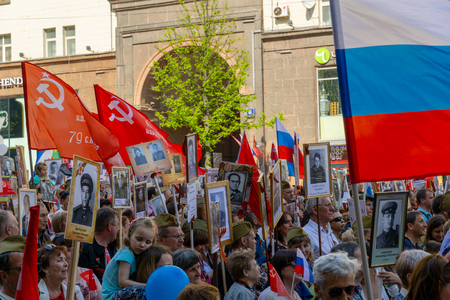 MOSCOW, RUSSIA - MAY 9, 2019: Immortal regiment procession in Victory Day. Thousands of people marching to the Red Square with flags and portraits in commemoration of soldiers of World War IIのeditorial素材