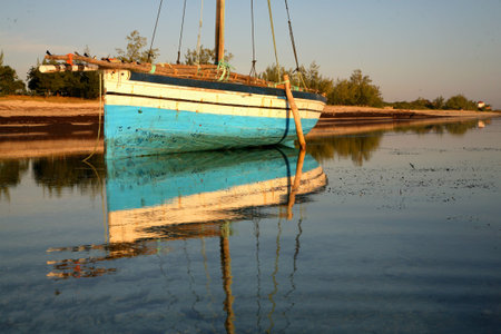 Blue dhow floating on the waters.