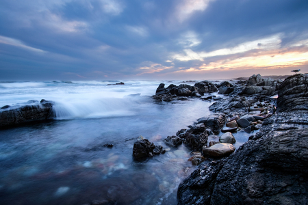 A stormy sunset by the beachの写真素材