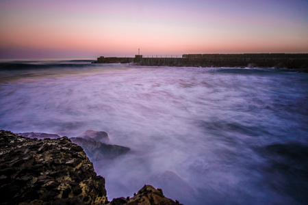 A silky view of the ocean during the sunriseの写真素材