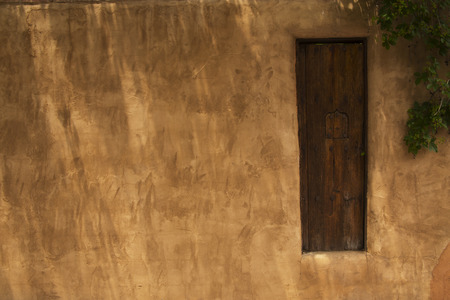 Wooden Gate in an Adobe Fence with a Security Window, Santa Fe, New Mexicoの写真素材