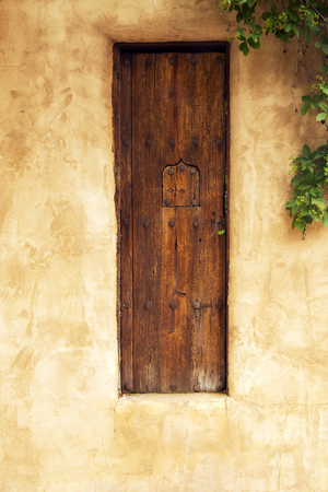 Old Wooden Gate with Security Window in Santa Fe, New Mexicoの写真素材