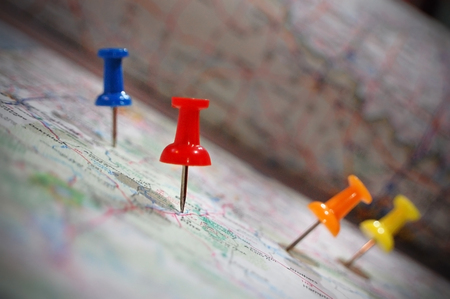 Close-up shot of push pins in an atlas.の写真素材