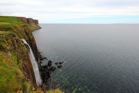 Waterfall cascading down cliff at Kilt Rock, Isle of Skye, Scotlandの写真素材