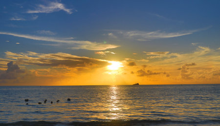Tranquil sunset at Mon Choisy Beach Mauritiusの写真素材