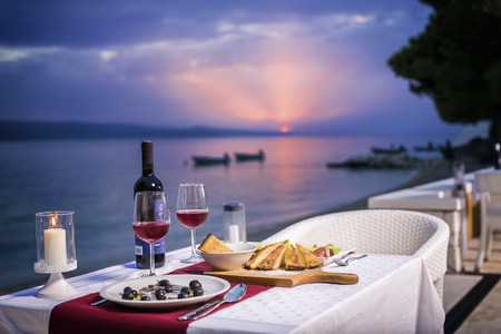 Romantic sunset dinner  on beachの写真素材