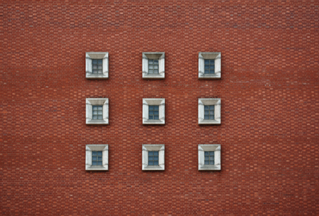 9 concrete windows square and a red brick wallの写真素材
