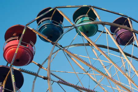 amusement park carousel on blue sky big wheelの写真素材