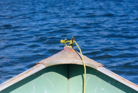 yellow rope in front of a shallop on a lakeの写真素材