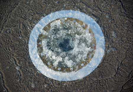 water flood sewage overflow circle hole on concrete floorの写真素材