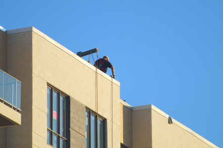 worker on top building roof construction site concrete structureの写真素材