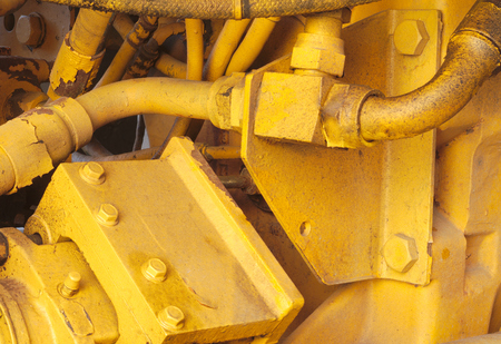 yellow motor engine machine excavator hydraulic tractor vehicle closeupの写真素材