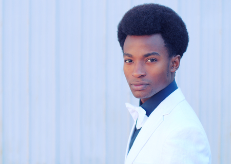 young man wearing bow tie and white jacket handsome portraitの写真素材