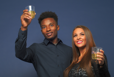 interracial couple drinking beer or wine happy young people cocktail partyの写真素材