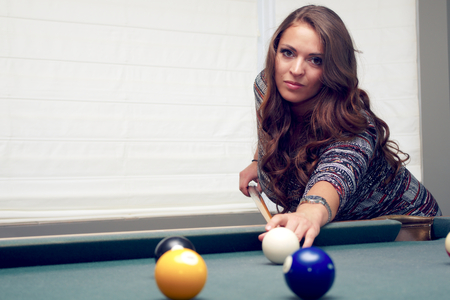 young women playing pool billiards fun activity recreation bar ball game の写真素材